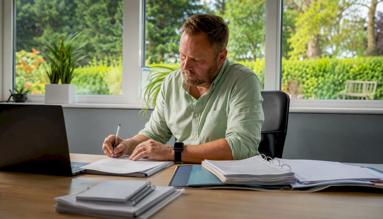 Care agency manager reviewing compliance documents