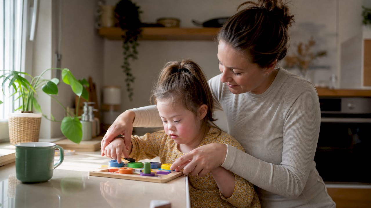 Carer helping child with daily tasks at home