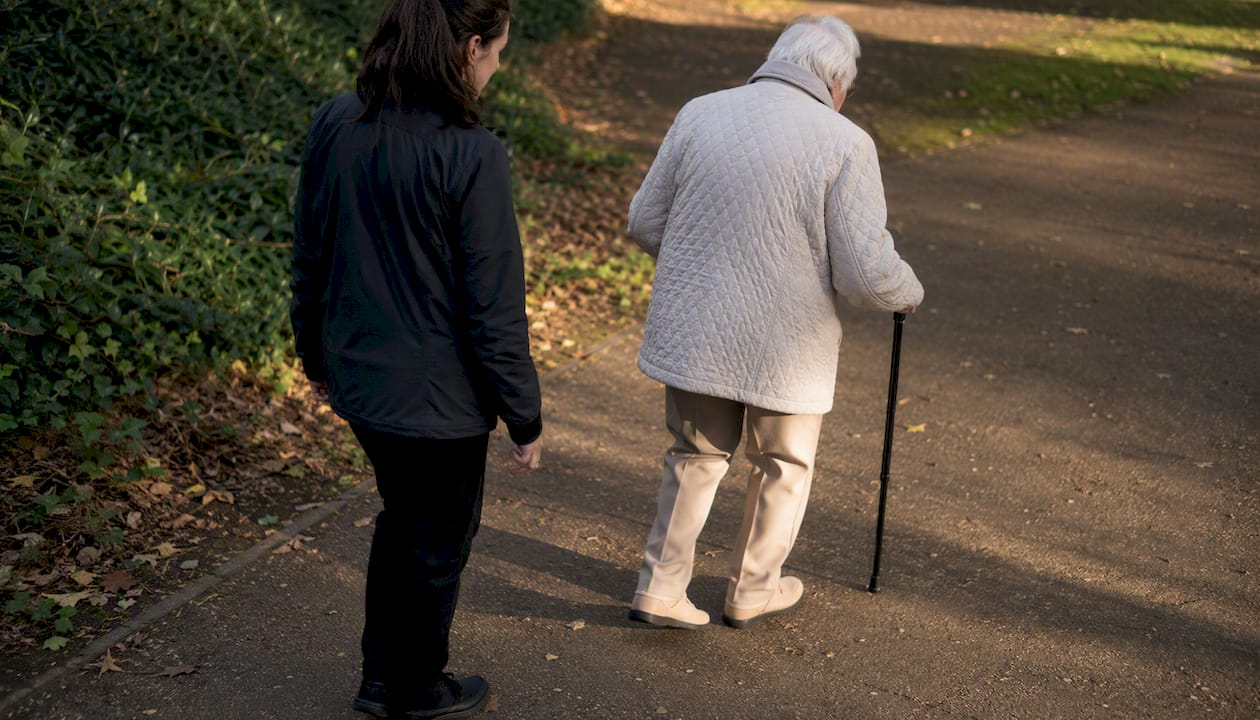Mobility assessor observing walking outside