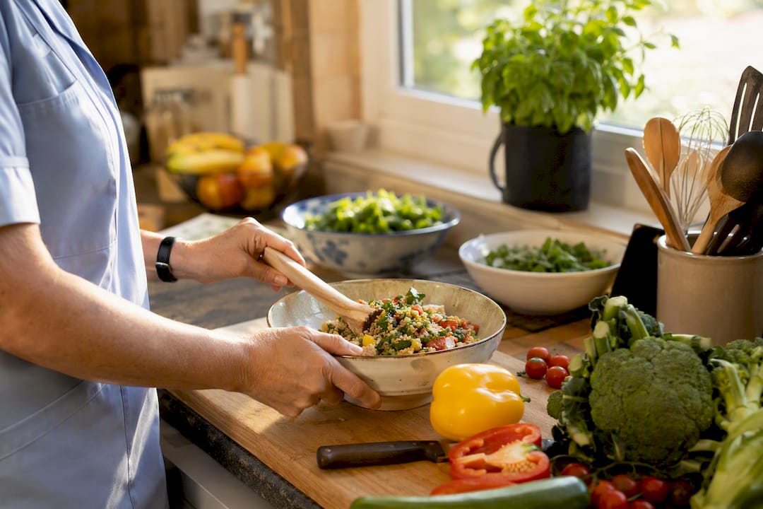 Carer chopping vegetables for client meal