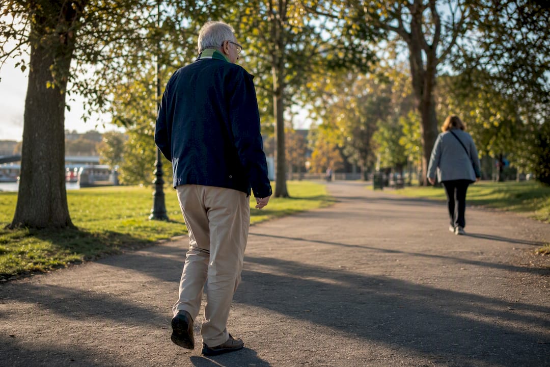 Older adult walking comfortably with catheter