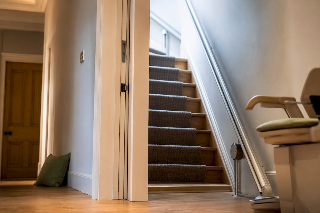 Stairlift beside widened doorway in London home