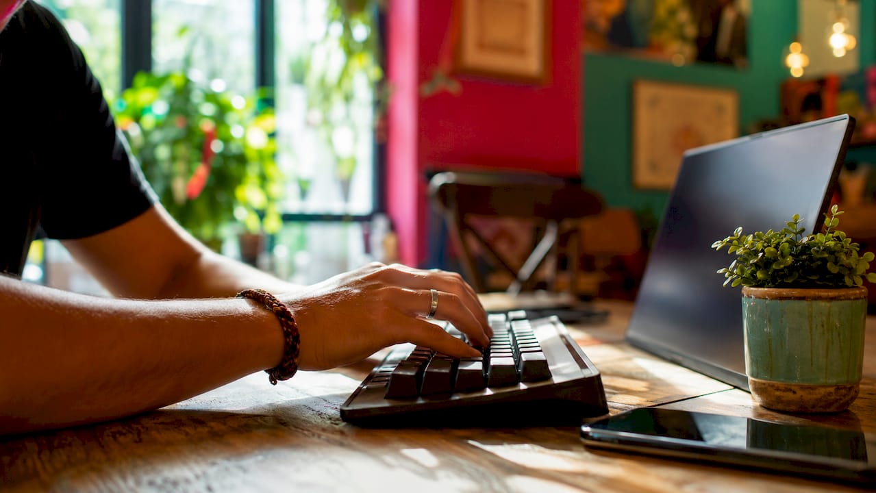 Hands typing on keyboard for trading