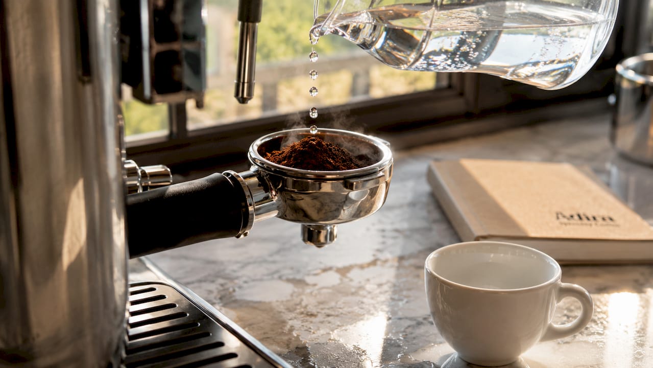 Close-up of espresso extraction with mineral water