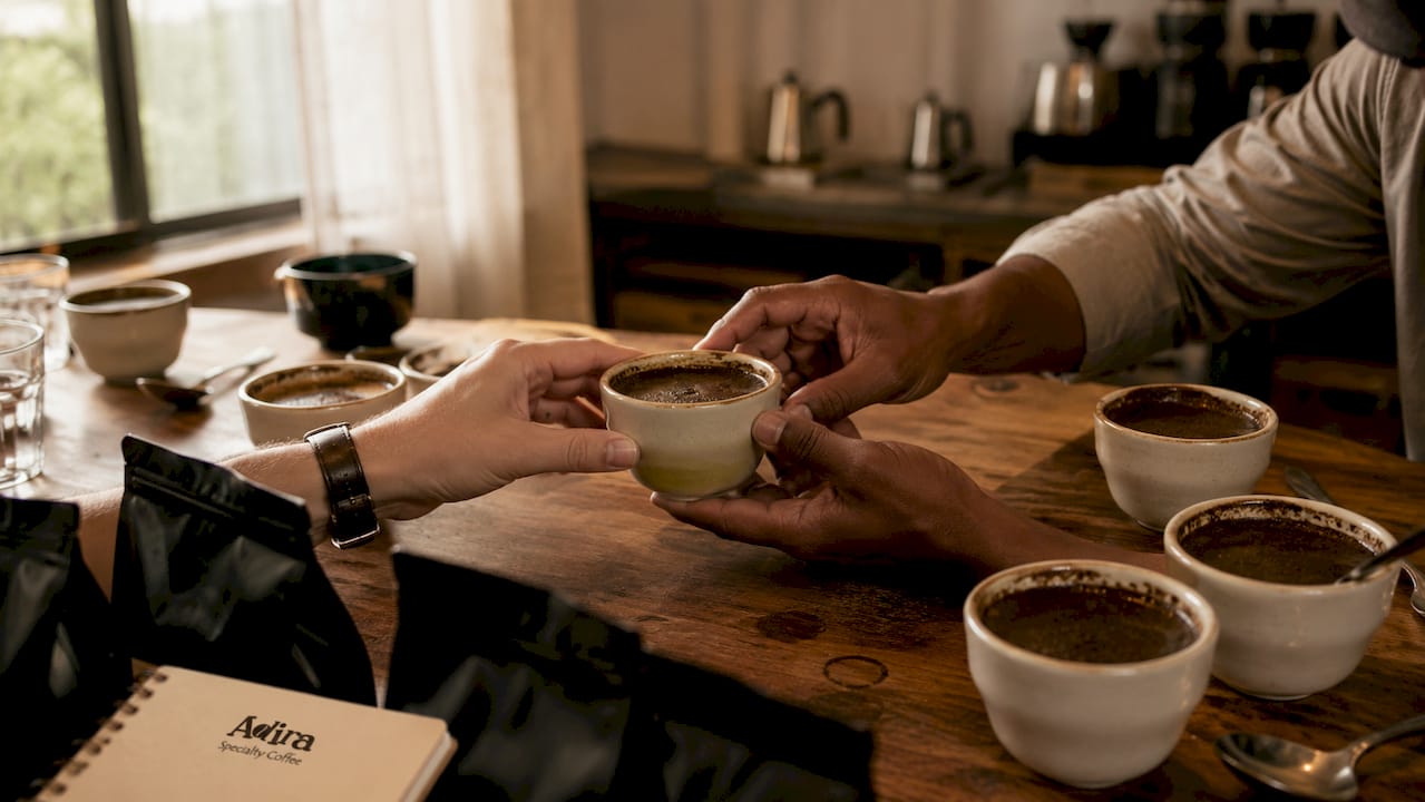 Close-up of hands during coffee cupping session