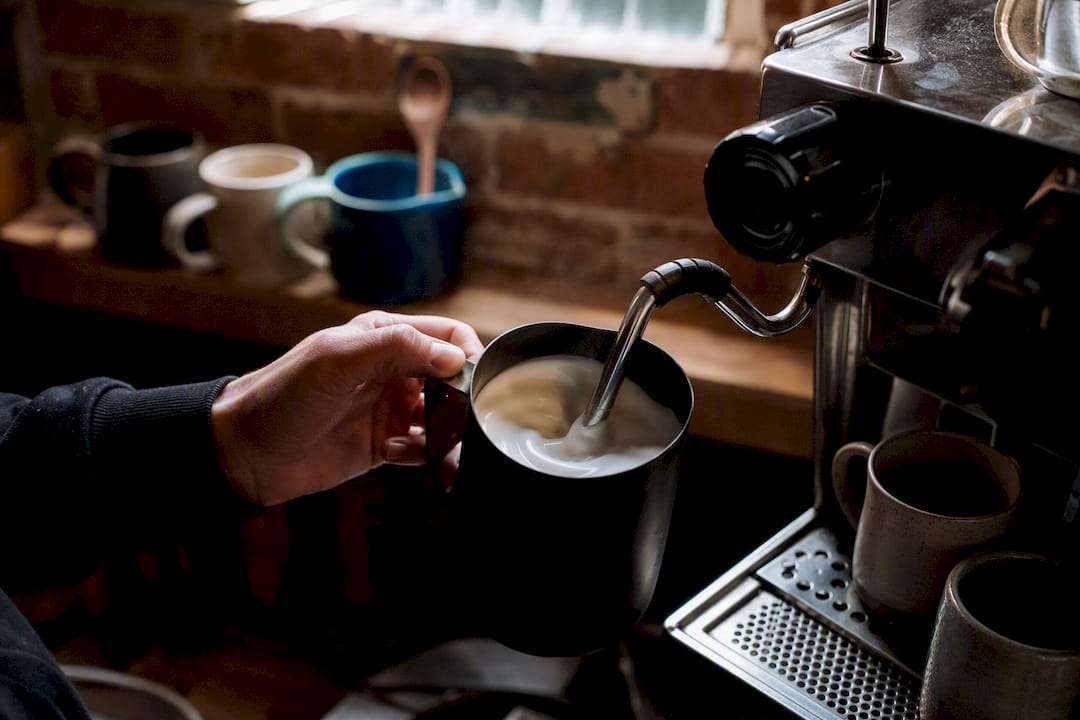 Hand steaming milk for microfoam in pitcher