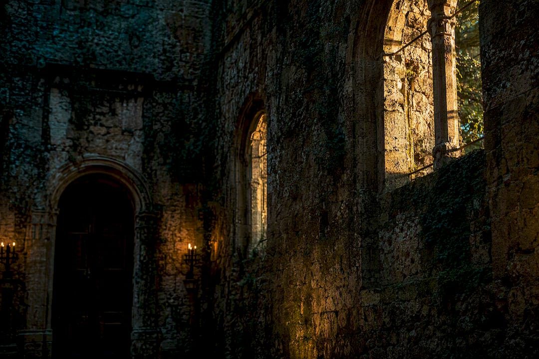 Textured stone castle wall with window