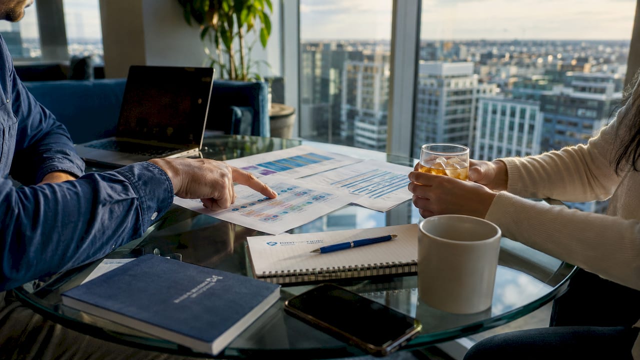 Hands collaborating over remote hiring checklist