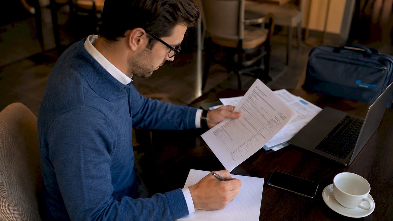Professional reviewing IRS Form SS-8 and notes at desk