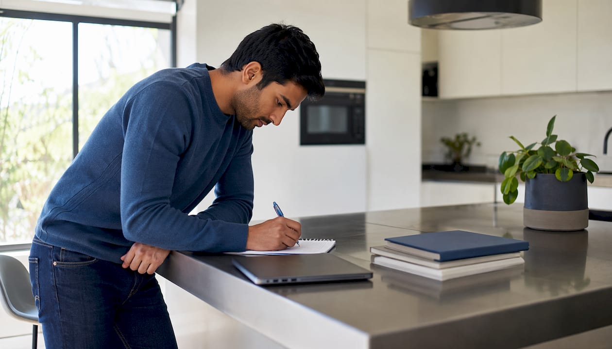 Man writing business justification notes