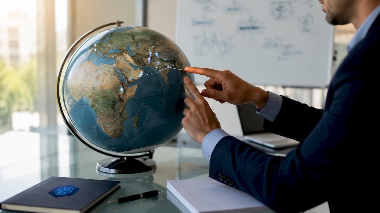 Hands pointing at globe showing CDN network