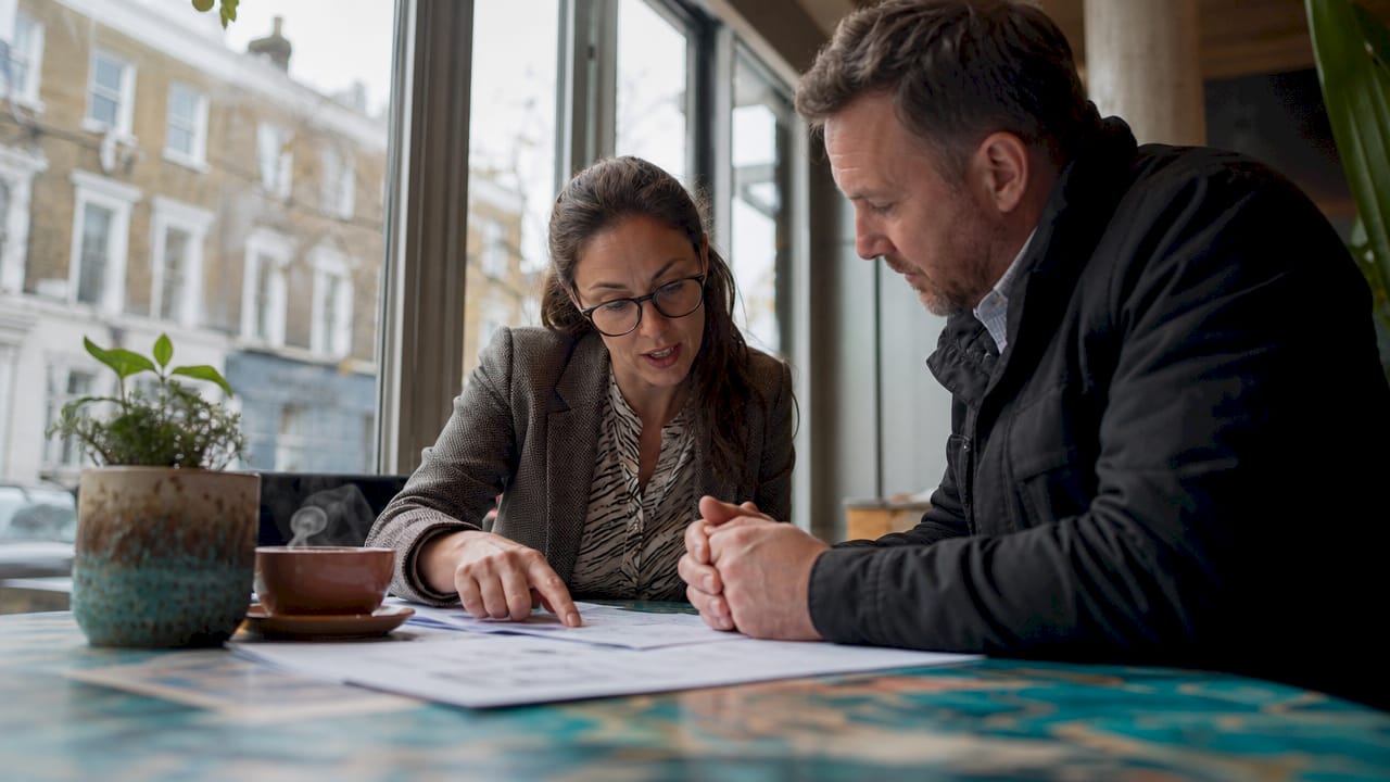 Architect and contractor discussing building regulations