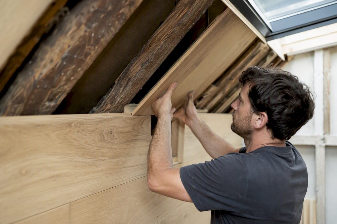 Hands fitting oak timber in Victorian loft conversion
