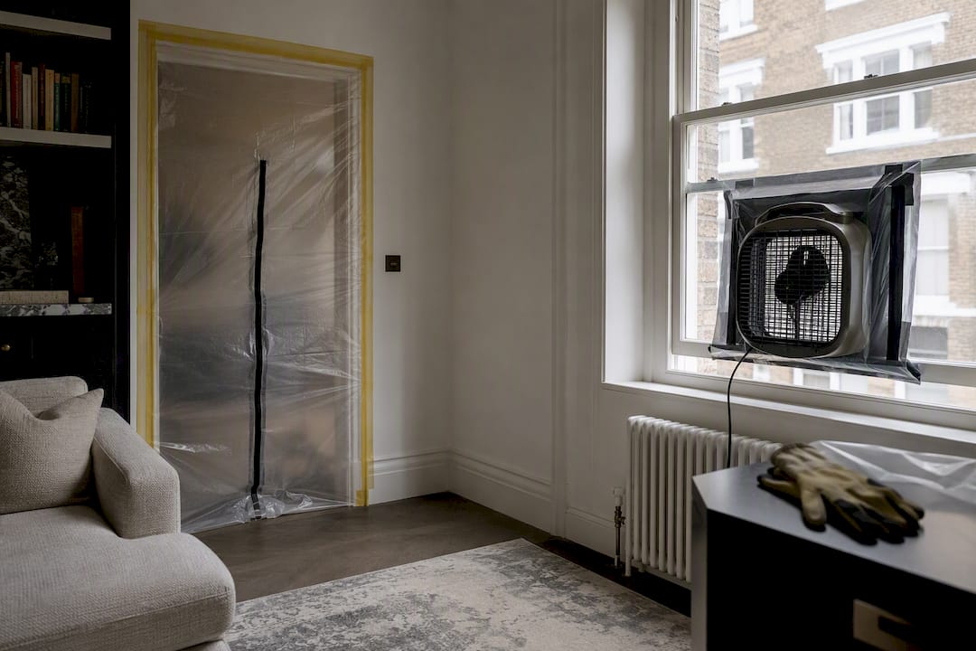 Plastic barrier and exhaust fan isolating renovation zone