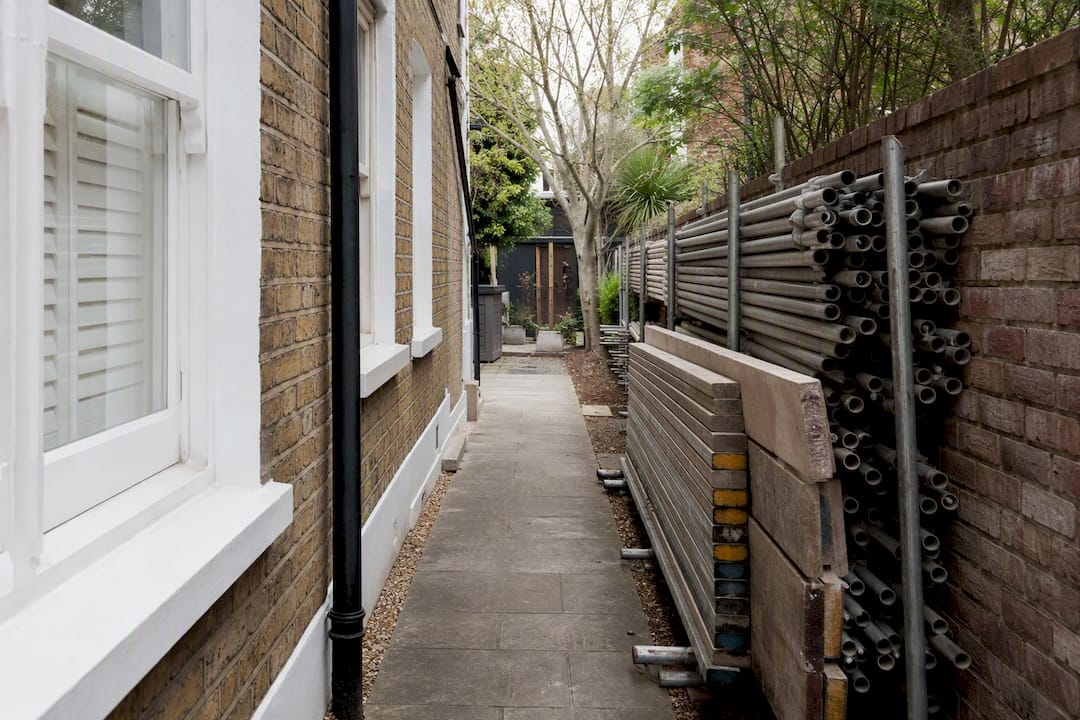Narrow side alley providing scaffold access