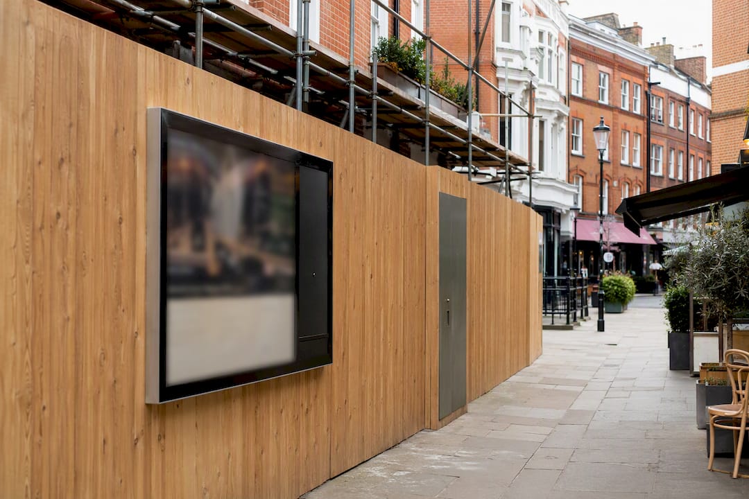 Managed refurbishment hoarding beside London café parade