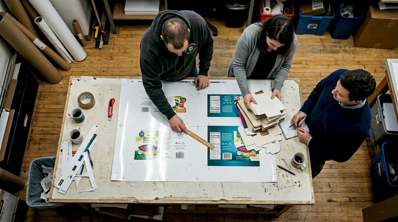 Team reviewing large packaging print proof