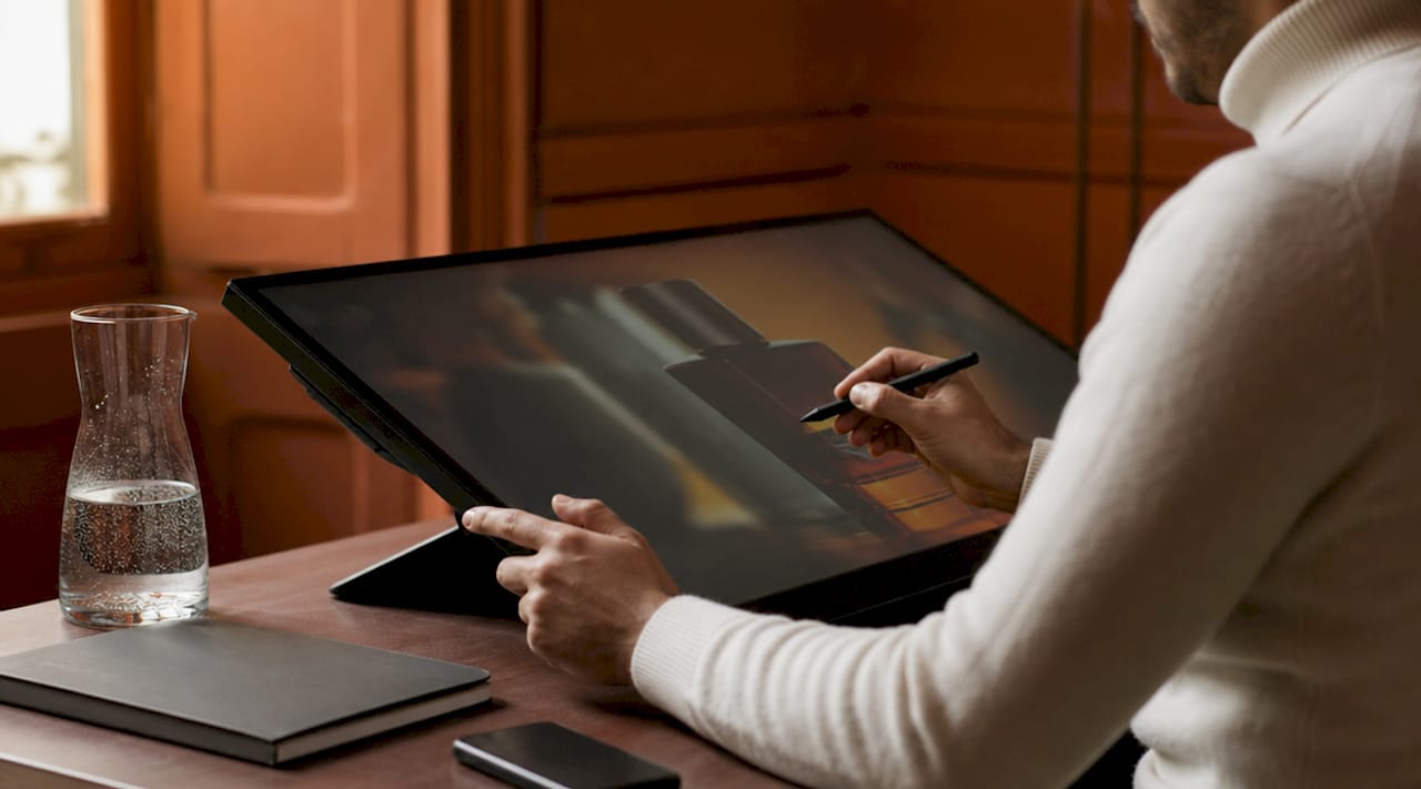Designer refining packaging artwork on touchscreen