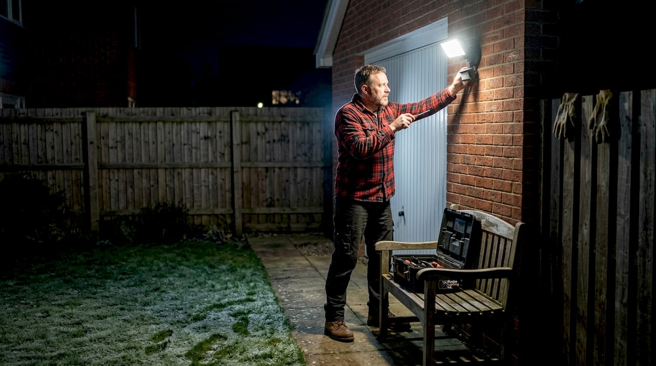 Homeowner adjusts motion sensor security light