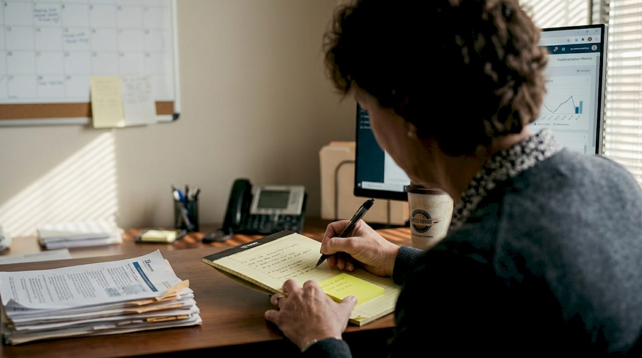 Manager reviewing change initiative dashboard reports