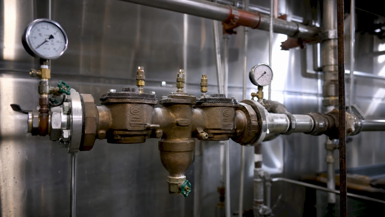 Close-up of RPZ valve and piping in utility room