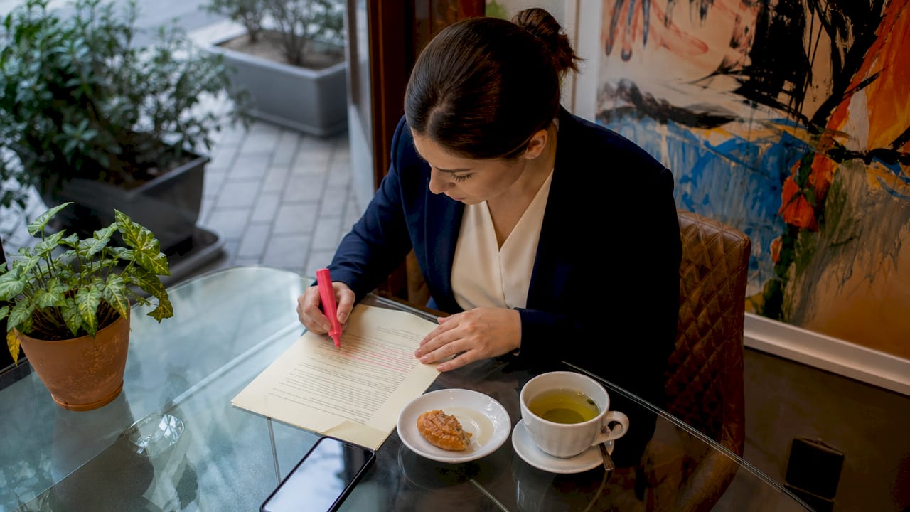 Woman highlighting vendor contract clauses