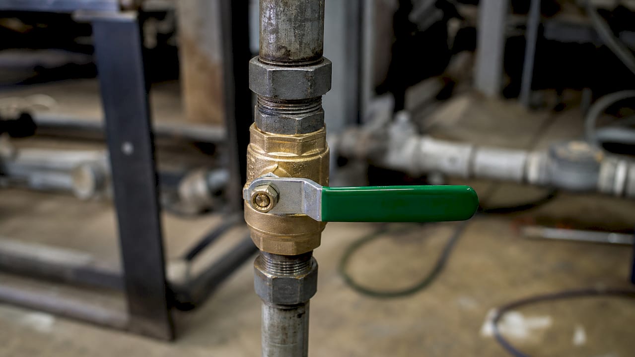 Close-up of ball valve closed on copper pipe