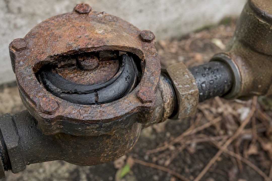 Corroded backflow valve with worn seal close-up