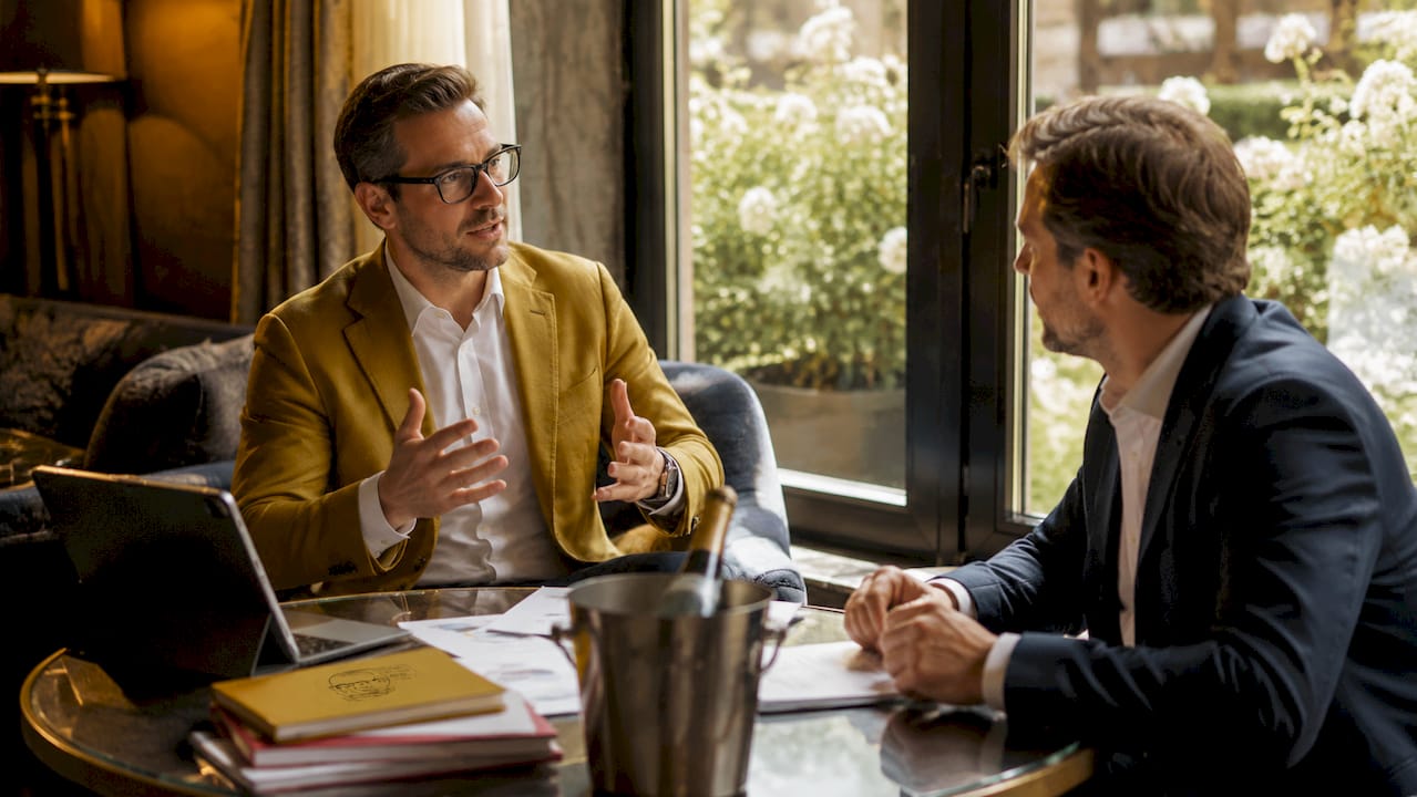 Zwei Firmenvertreter besprechen gemeinsam die Organisation ihrer Getränkebestellung.