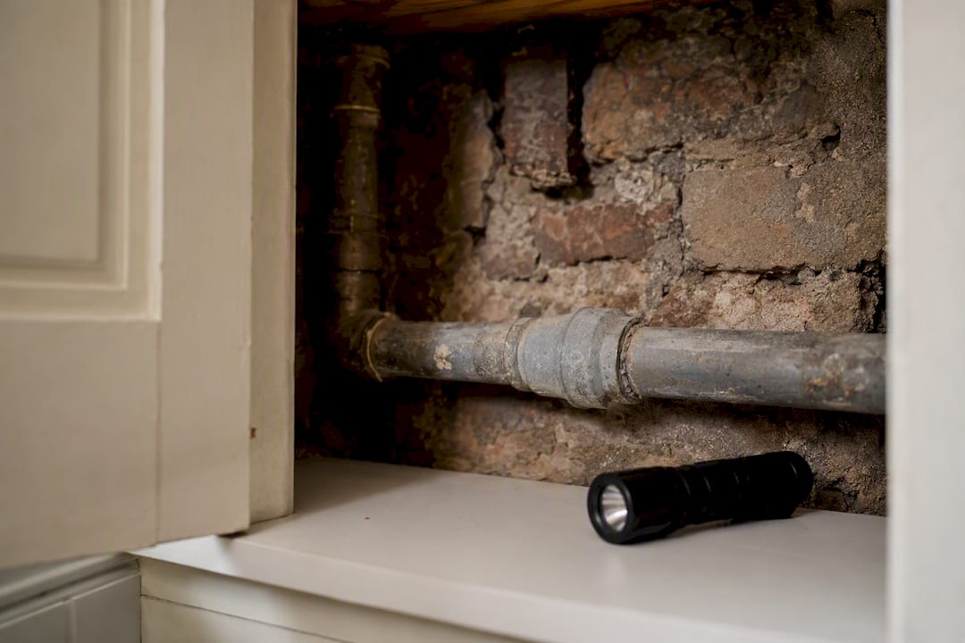 Exposed suspected lead water supply pipe