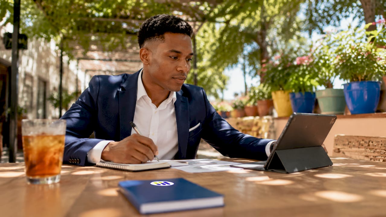 Financial analyst taking notes in office conference room