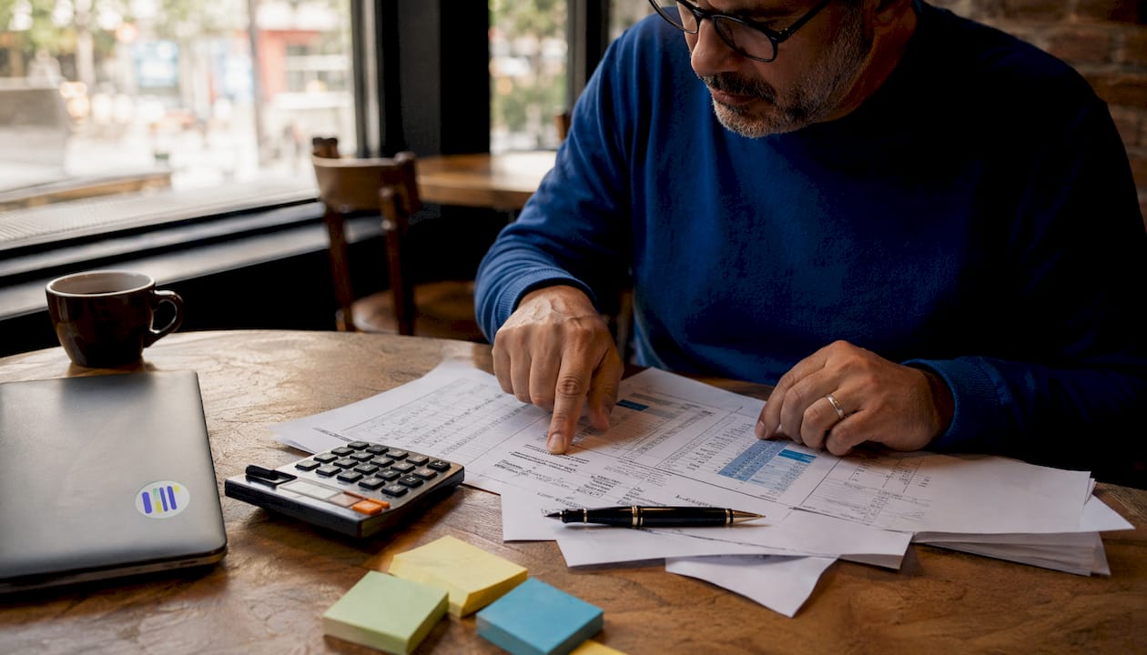 Hands calculating earnings per share formulas