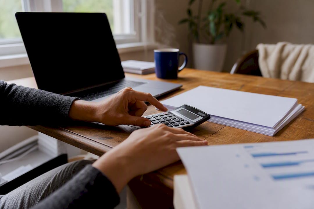 Hands calculating cash flow with financial documents