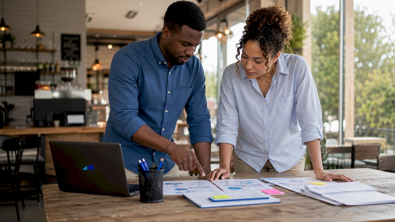 Two professionals discussing CFO cost comparison