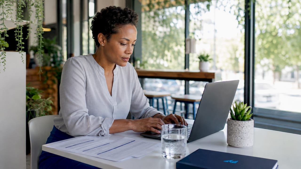 Business owner setting up payroll on laptop