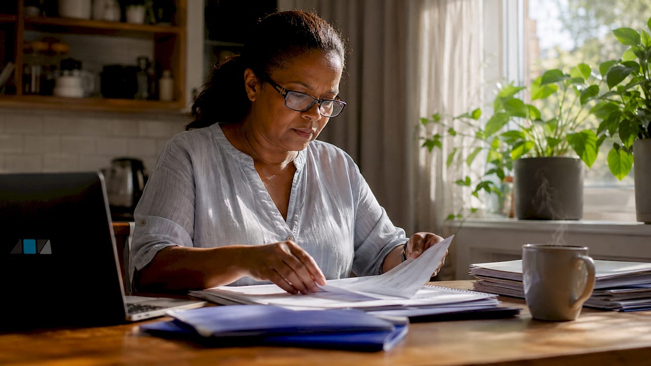 Woman sorting SARS audit documents at desk