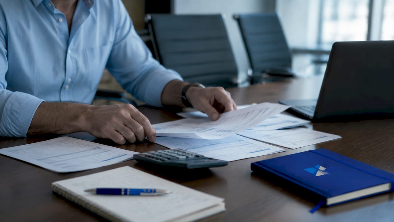 Hands reviewing tax documents for audit
