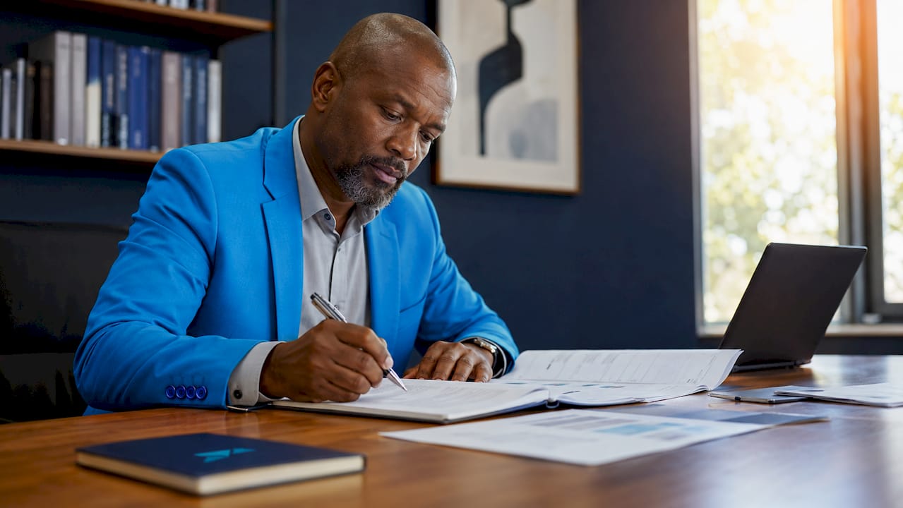 Auditor examining financial statements at table