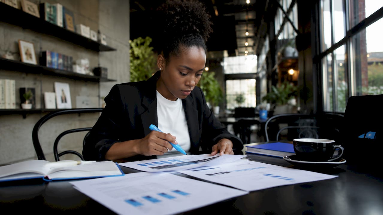 Entrepreneur reviewing marketing charts in co-working space