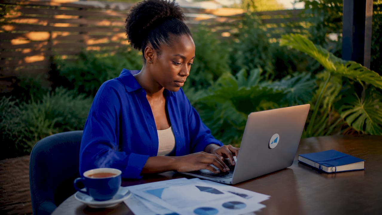 Hands typing SEO strategies on laptop keyboard
