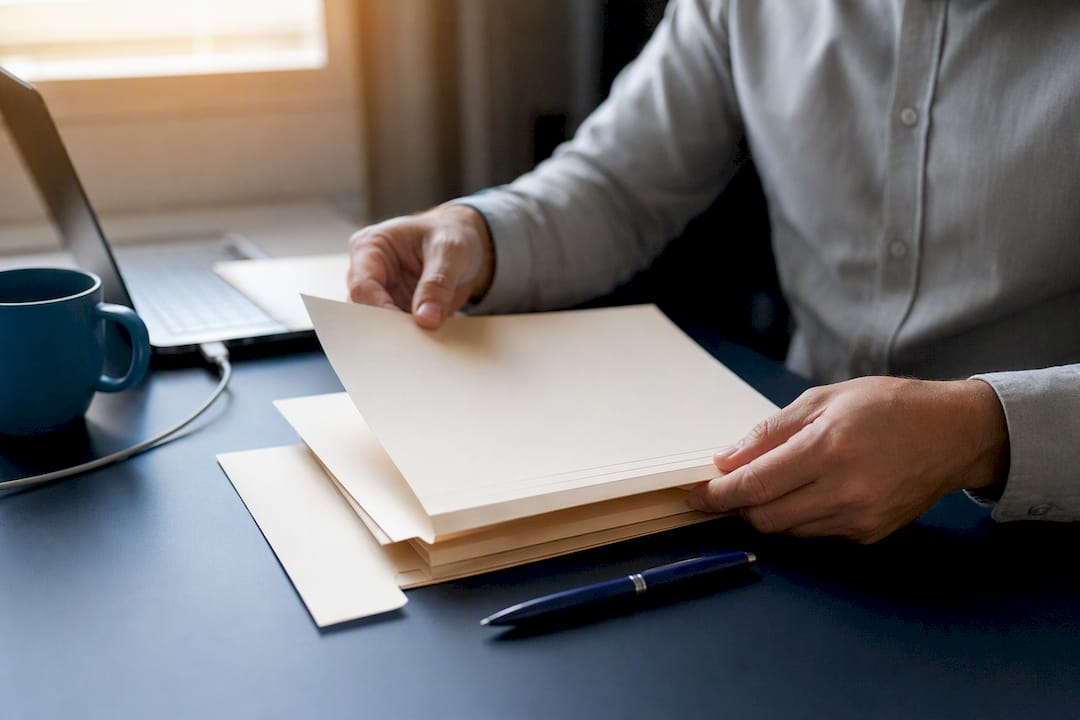 Hands arranging succession planning documents