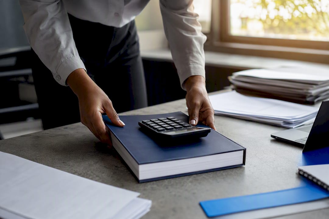 Hands with tax compliance materials