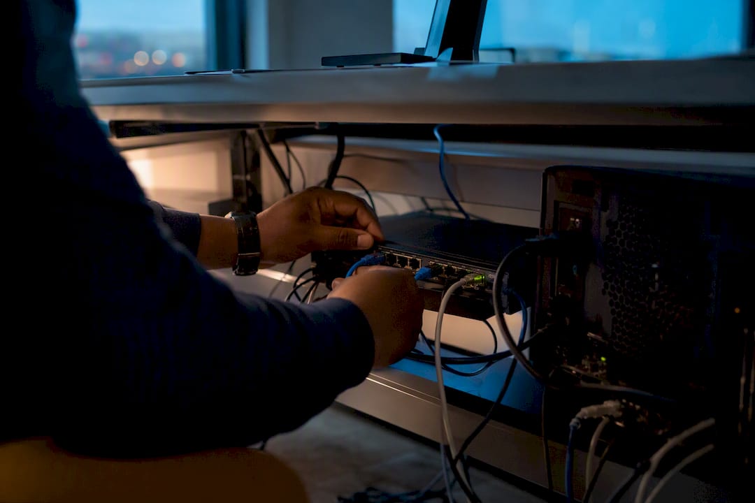 Hands connecting bookkeeping infrastructure cables