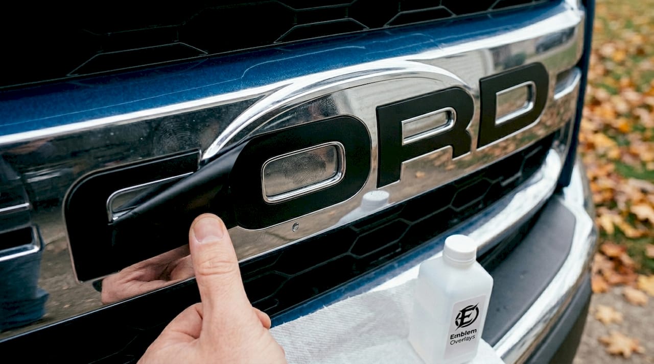 Close-up Ford emblem overlay installation