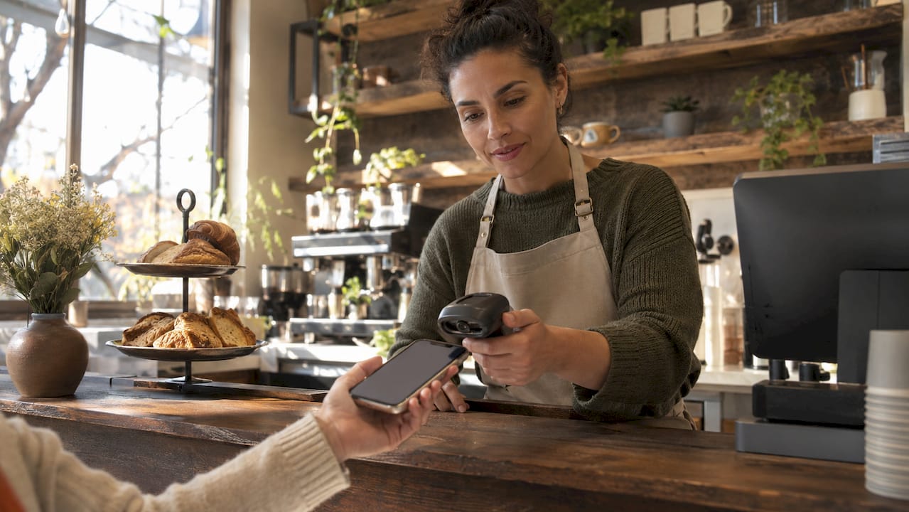 Barista scanning digital stamp card on smartphone