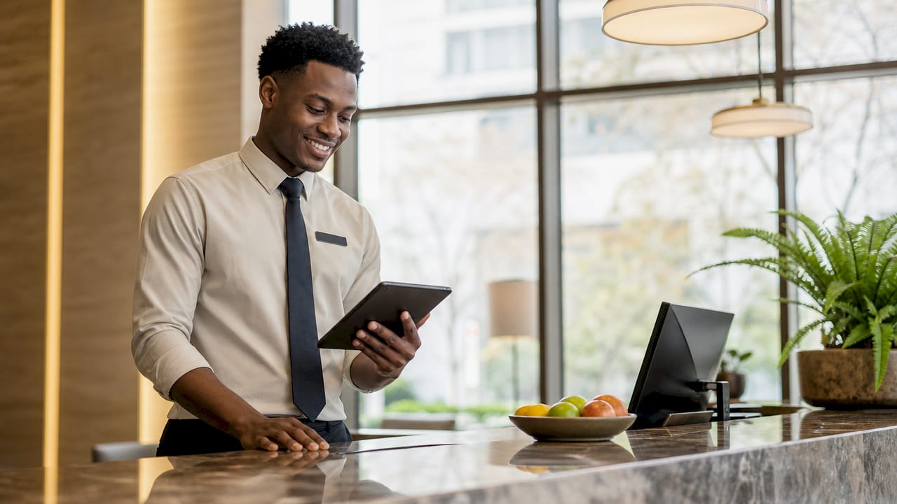 Hotel front desk agent using tablet for automation
