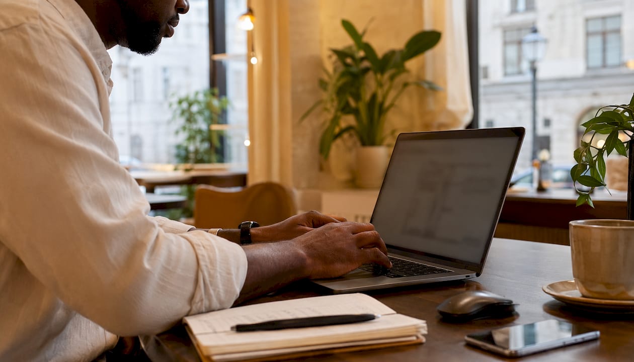 Hands typing on laptop configuring menu system