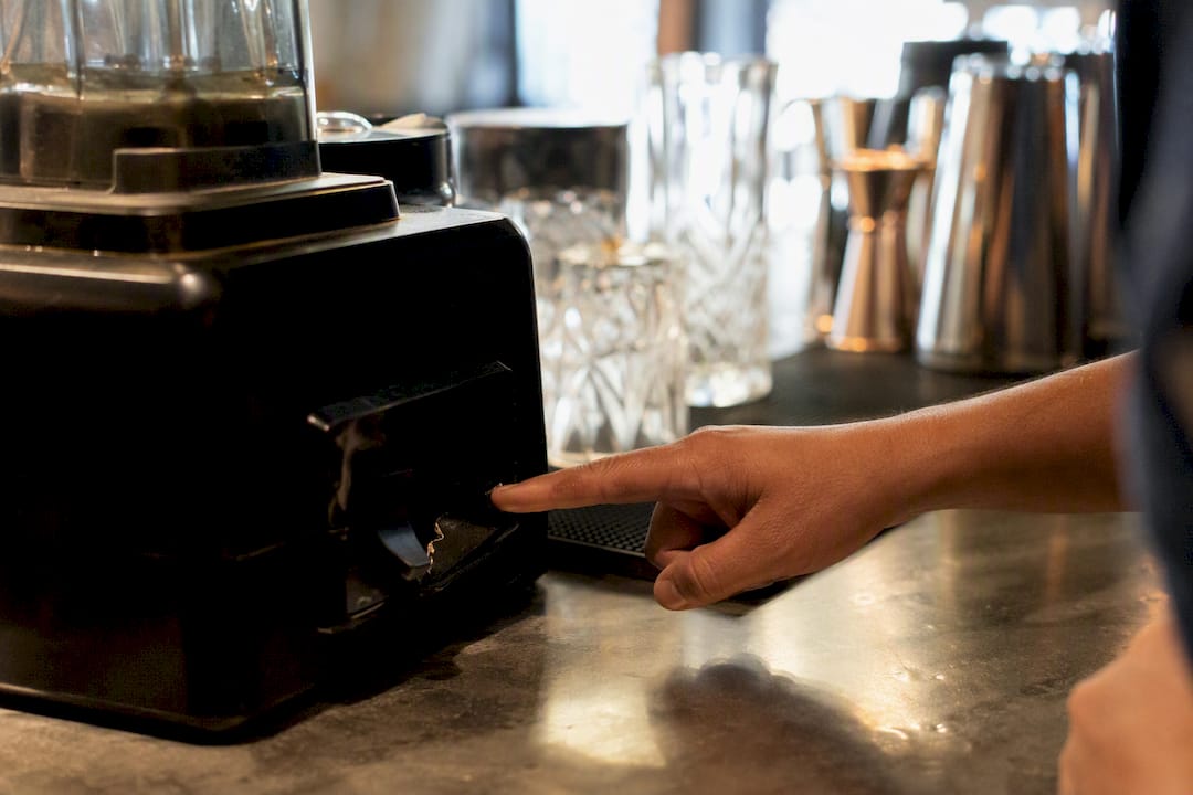 Hand pointing at broken coffee machine button