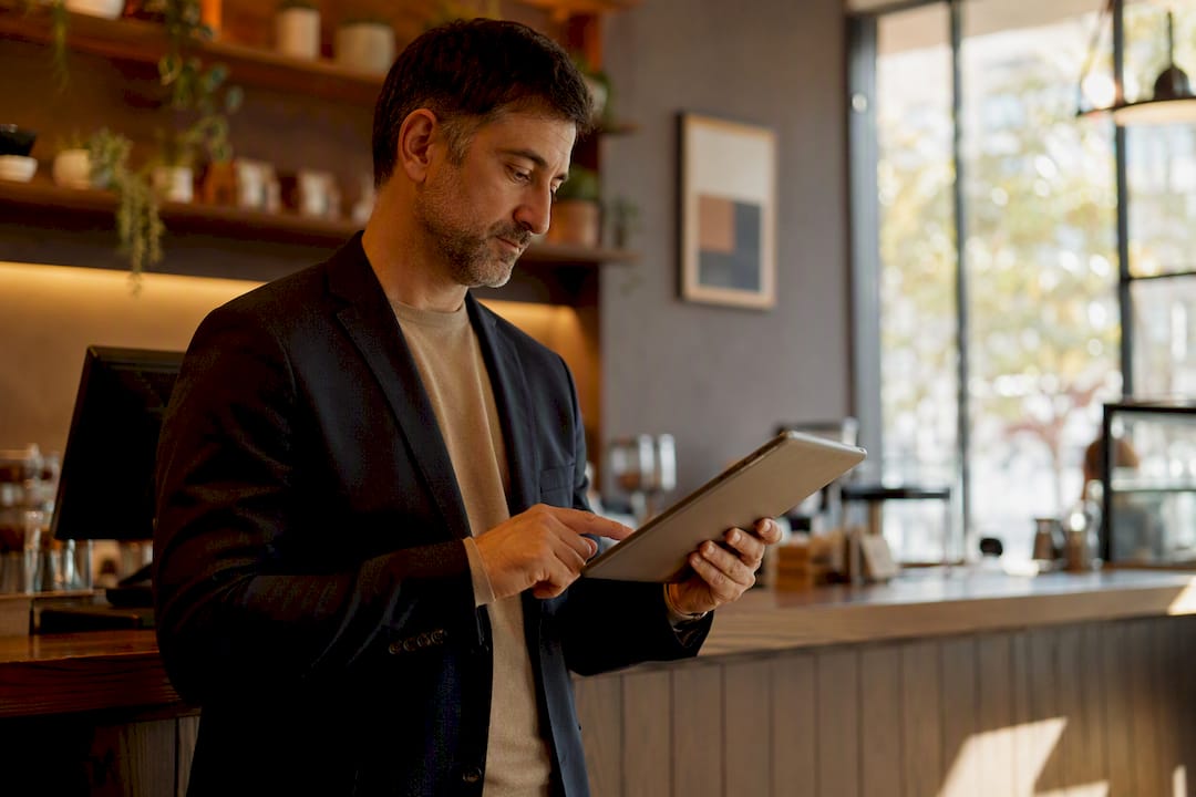 Hands adjusting a restaurant menu layout schematic on wall
