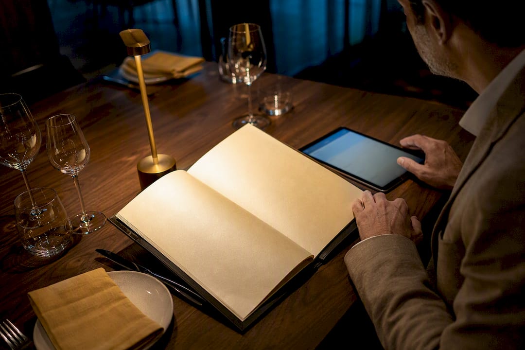 Paper and digital menus on restaurant table